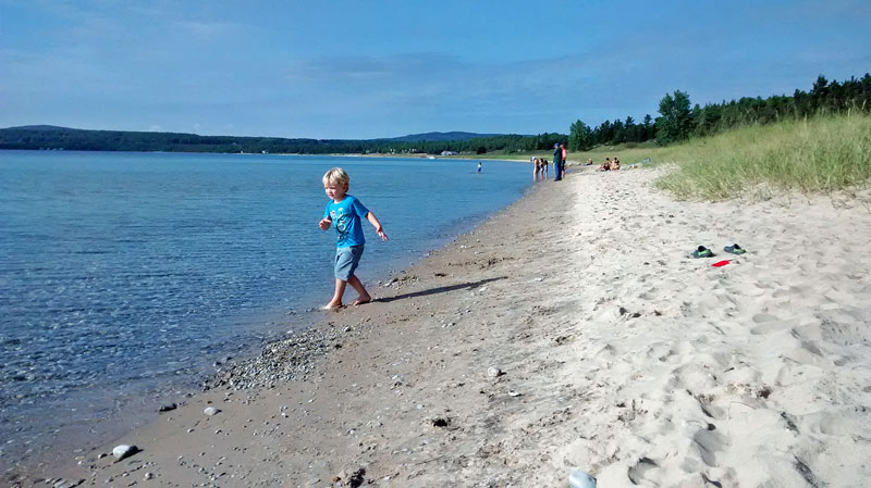 throwing stones at beach petosky state park